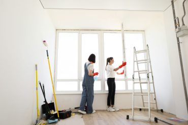 Hem attractive caucasian girls making house cleaning after repair